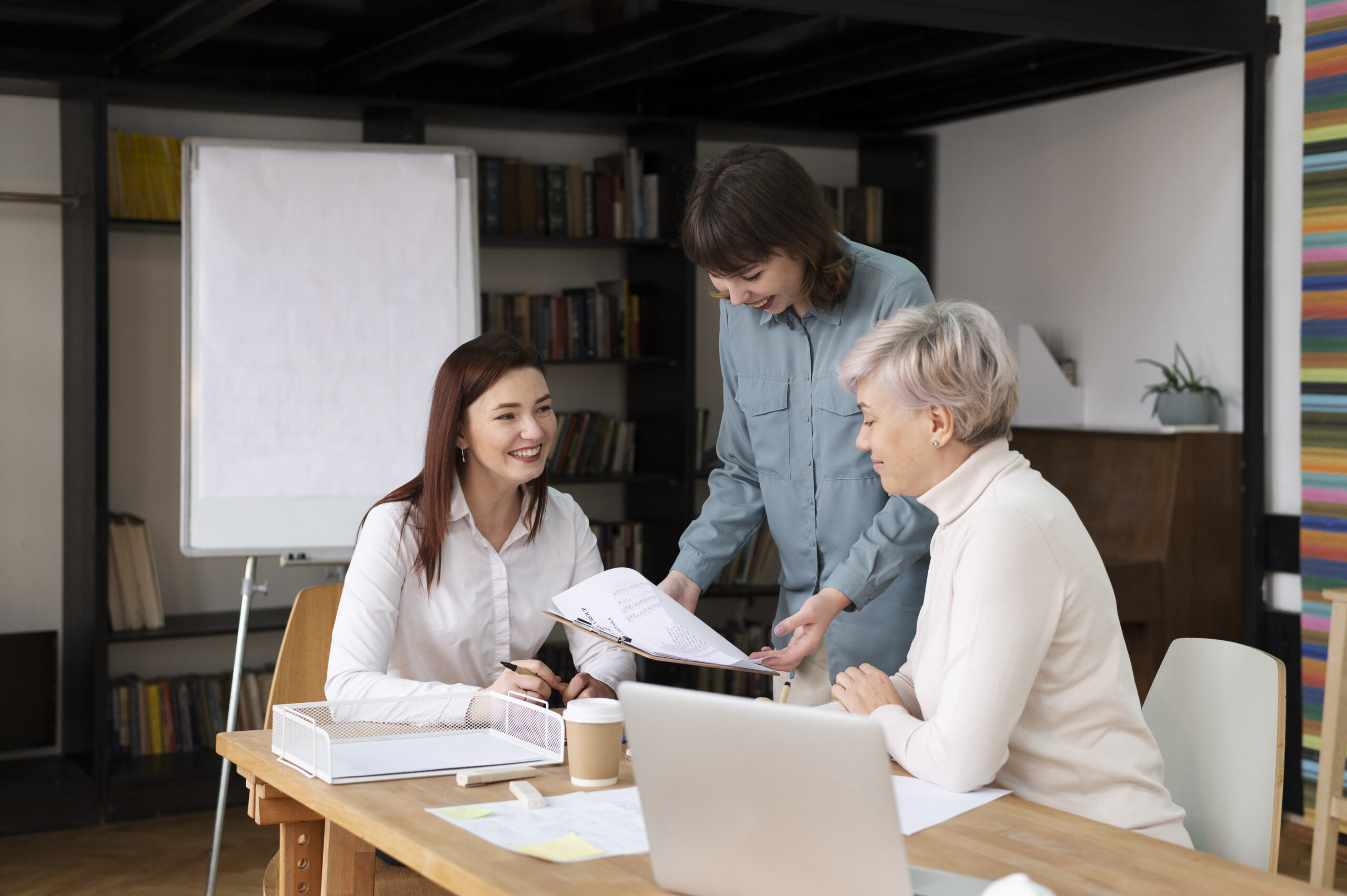 Education professionals discussing documents in an office