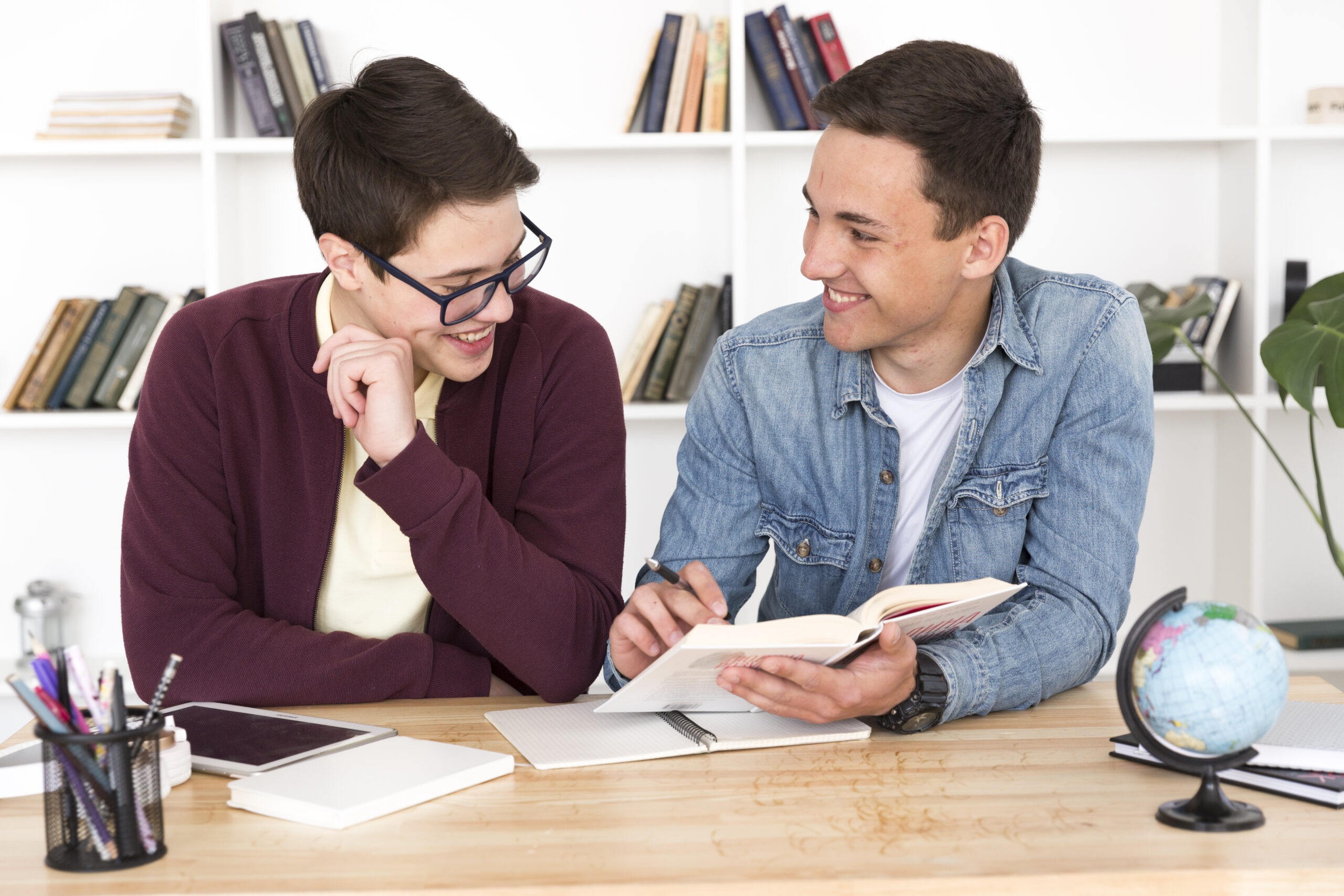 Tutor helping a student with a book